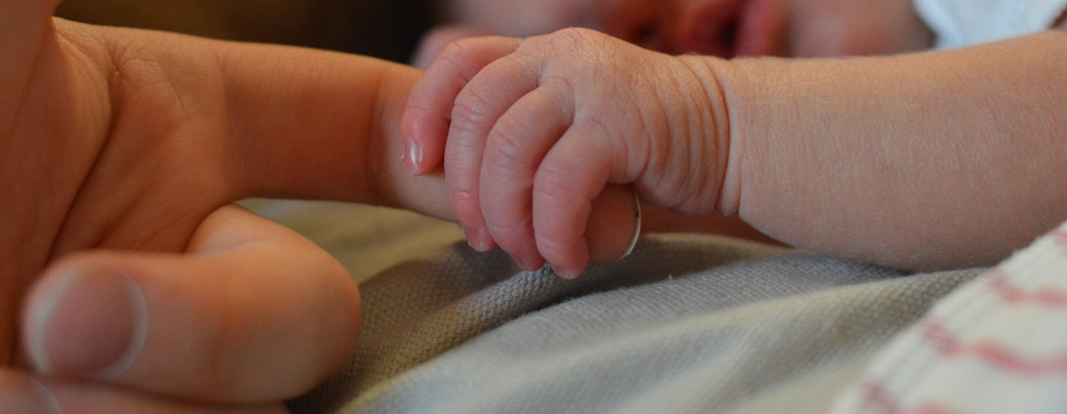Baby touching finger